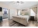Charming main bedroom featuring a tufted headboard bed, hardwood floors, and a modern color palette at 18516 Snowdonia Dr, Land O Lakes, FL 34638