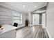 Beautiful home office featuring natural light, wood floors, and a modern desk at 18516 Snowdonia Dr, Land O Lakes, FL 34638