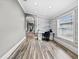 Bright home office featuring a modern desk, stylish accent wall and light wood floors at 18516 Snowdonia Dr, Land O Lakes, FL 34638