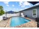 A sunny backyard pool, basketball hoop, and lounge seating at 18516 Snowdonia Dr, Land O Lakes, FL 34638