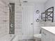 Stylish bathroom showcasing tiled walls, modern showerhead, and functional shelving at 1877 Pine Cone Cir, Clearwater, FL 33760
