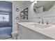Bright bathroom featuring a white vanity with marble countertop and modern fixtures at 1877 Pine Cone Cir, Clearwater, FL 33760