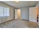 Spacious bedroom featuring neutral carpeting, ample natural light, and closet and ensuite access at 1877 Pine Cone Cir, Clearwater, FL 33760