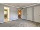 Carpeted bedroom featuring neutral paint and multiple doorways at 1877 Pine Cone Cir, Clearwater, FL 33760