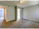 Neutral-toned bedroom with carpet and access to other rooms, creating a sense of flow at 1877 Pine Cone Cir, Clearwater, FL 33760