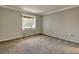 Carpeted bedroom featuring neutral paint and a window at 1877 Pine Cone Cir, Clearwater, FL 33760