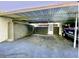 Carport featuring a covered parking area, with ample space for vehicles and storage at 1877 Pine Cone Cir, Clearwater, FL 33760