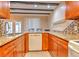 Kitchen with wood cabinets, granite countertops, and stainless steel appliances at 1877 Pine Cone Cir, Clearwater, FL 33760