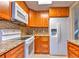 Updated kitchen with wood cabinets, stainless steel appliances and granite countertops at 1877 Pine Cone Cir, Clearwater, FL 33760