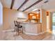 Open kitchen and breakfast bar featuring granite countertops and stylish bar seating at 1877 Pine Cone Cir, Clearwater, FL 33760