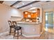 Open kitchen and breakfast bar featuring granite countertops and stylish bar seating at 1877 Pine Cone Cir, Clearwater, FL 33760
