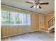 Bright living room with vinyl floors, fan, and a large window letting in natural light at 1877 Pine Cone Cir, Clearwater, FL 33760