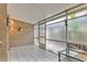 Enclosed patio with tile flooring, offering a bright and airy space for relaxation or entertaining at 1877 Pine Cone Cir, Clearwater, FL 33760