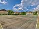 Community tennis courts provide residents a recreational space with lush landscaping and well-maintained playing surfaces at 1877 Pine Cone Cir, Clearwater, FL 33760