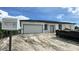 Home exterior featuring an attached garage, under construction at 18773 Lake Worth Blvd, Port Charlotte, FL 33948