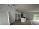 An open kitchen with white cabinets, stainless steel appliances, and a kitchen island at 18773 Lake Worth Blvd, Port Charlotte, FL 33948