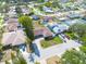 A well maintained house with green lawn and mature trees is situated in a suburban neighborhood with community pool at 1913 Libby Ct, Holiday, FL 34690