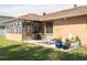 Outdoor patio with a grill and dining set surrounded by a well-maintained lawn at 1913 Libby Ct, Holiday, FL 34690