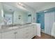 Bathroom features a double vanity, granite countertops, and a shower at 1913 Libby Ct, Holiday, FL 34690