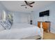 Comfortable bedroom features a queen size bed, light blue walls, and hardwood floors at 1913 Libby Ct, Holiday, FL 34690