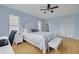 Comfortable bedroom features a queen size bed, light blue walls, and hardwood floors at 1913 Libby Ct, Holiday, FL 34690