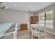 Dining area with wood-look floors, modern lighting, and large window at 1913 Libby Ct, Holiday, FL 34690