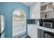 Bright kitchen with window, white cabinetry, and mosaic backsplash at 1913 Libby Ct, Holiday, FL 34690