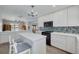 Bright kitchen featuring stainless steel appliances, white cabinets, and a central island at 1913 Libby Ct, Holiday, FL 34690