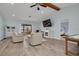 Bright living room featuring light blue walls, modern furniture, and plenty of natural light at 1913 Libby Ct, Holiday, FL 34690