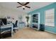 Inviting home office with tile floor, bright blue accent wall, and built-in desk at 1913 Libby Ct, Holiday, FL 34690