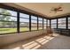 Enclosed sunroom with large windows overlooking the yard and tiled floors at 1913 Libby Ct, Holiday, FL 34690
