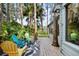 Back patio with colorful chairs overlooking a lush green lawn and mature trees at 22004 Dupree Dr, Land O Lakes, FL 34639