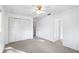 Sunlit bedroom featuring neutral carpet, a large closet, and white paint throughout, ceiling fan at 22004 Dupree Dr, Land O Lakes, FL 34639