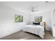 Bright bedroom featuring a ceiling fan, two windows and carpeted floors at 22004 Dupree Dr, Land O Lakes, FL 34639