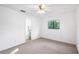 Bedroom featuring neutral carpet, a window view, and white paint throughout, ceiling fan at 22004 Dupree Dr, Land O Lakes, FL 34639