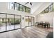Bright dining area boasts walls of windows, modern flooring, vaulted ceiling, and contemporary furnishings at 22004 Dupree Dr, Land O Lakes, FL 34639