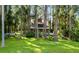 Exterior facade of home surrounded by trees and green grass, with boat and deck at 22004 Dupree Dr, Land O Lakes, FL 34639