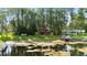 Secluded waterfront home with private dock surrounded by lush greenery and mature trees at 22004 Dupree Dr, Land O Lakes, FL 34639