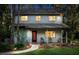 Inviting two-story home with a covered porch, manicured landscaping, and an illuminated walkway at 22004 Dupree Dr, Land O Lakes, FL 34639