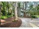 Back exterior of the home featuring a stone path and lush foliage at 22004 Dupree Dr, Land O Lakes, FL 34639