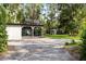 Exterior view of the charming home with a detached garage at 22004 Dupree Dr, Land O Lakes, FL 34639