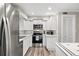 Bright kitchen features white cabinetry, stainless steel appliances and laminate countertop at 22004 Dupree Dr, Land O Lakes, FL 34639