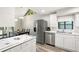 Open concept kitchen with stainless steel appliances, an island, and a dining area with natural light at 22004 Dupree Dr, Land O Lakes, FL 34639