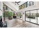 Spacious living room with spiral staircase, fireplace, and floor to ceiling windows at 22004 Dupree Dr, Land O Lakes, FL 34639