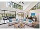 Bright living room featuring vaulted ceiling, clerestory windows, and access to bonus sunroom at 22004 Dupree Dr, Land O Lakes, FL 34639