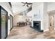 Open concept living room with fireplace, dining area, and views of the backyard at 22004 Dupree Dr, Land O Lakes, FL 34639
