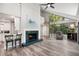 Cozy living room with fireplace, spiral staircase, and large windows overlooking the yard at 22004 Dupree Dr, Land O Lakes, FL 34639