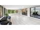 Light-filled sunroom with tiled flooring and views into the backyard at 22004 Dupree Dr, Land O Lakes, FL 34639