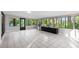 Light-filled sunroom with large windows, tile flooring, and a seamless connection to the outdoors at 22004 Dupree Dr, Land O Lakes, FL 34639