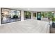 Bright sunroom featuring tile floors, sliding glass doors to other rooms, and views of nature at 22004 Dupree Dr, Land O Lakes, FL 34639